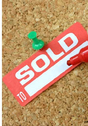sold tag on cork board